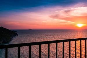 View of Sunset the balcony in the sea,with clouds and water reflection on Twilight sky beautiful orange colors background. photo