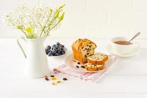 Homemade freshly baked cake loaf with raisins. Traditional treat for tea or coffee. Pound cake. Delicious breakfast. photo