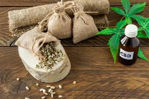 cannabis CBD oil hemp products - THC tincture and hemp leaves and seeds photo