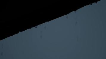 Rain and roof. Falling rain from the roof. Rain drops flow down from a roof down. video