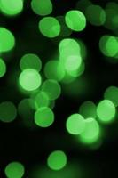 Green abstract Christmas blurred luminous background. Defocused artistic bokeh lights image photo