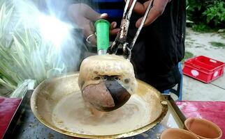 Close Up of Making Indian Tandoori Milk Tea or Chai . Selective Foc photo