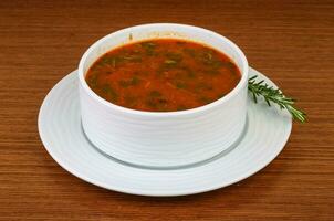 sopa de frijoles en un tazón sobre fondo de madera foto