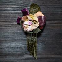 top view of leather and silk brooch as rose flower photo