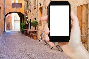 tourist photographs of old medieval street Ferrara photo