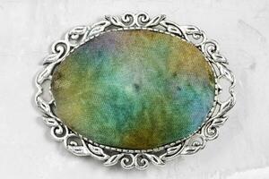 silver brooch with hand-colored silk batik on gray photo