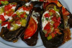 Grilled eggplant on the plate and wooden background photo