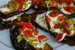 Grilled eggplant on the plate close up view photo