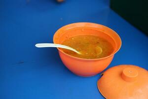 Ordinary orange bowl filled with chili photo