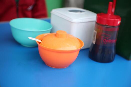 various containers consisting of containers of chili sauce, soy sauce, salt, and tissue on one table photo