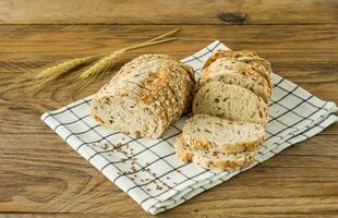 Gluten-free vegan bread and no animal products. Vegetarian bread with oatmeal, banana flavor, on a wooden rustic table, sliced and ready to serve. photo
