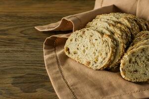 Gluten-free vegan bread and no animal products. Vegetarian bread with oatmeal, banana flavor, on a wooden rustic table, sliced and ready to serve. photo