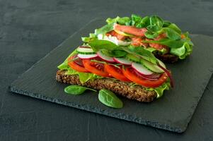 vegetables and smoked open sandwiches with cottage cheese, lattice, tomatoes and lemon on a slate. Healthy breakfast for diet photo