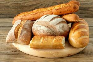 Types of homemade bread on the rustic wooden table. Homemade baked pastry. photo