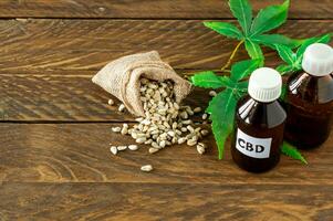 cannabis CBD oil hemp products - capsules and seeds of hemp photo