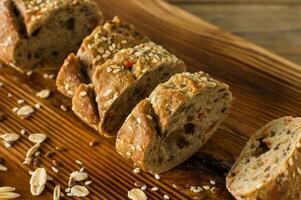 Gluten-free vegan bread and no animal products. Vegetarian bread with oatmeal, banana flavor, on a wooden rustic table, sliced and ready to serve. photo