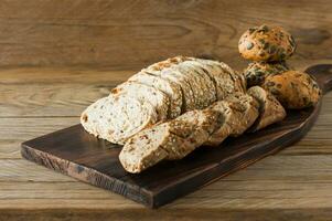 Gluten-free vegan bread and no animal products. Vegetarian bread with oatmeal, banana flavor, on a wooden rustic table, sliced and ready to serve. photo