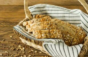 Gluten-free vegan bread with no animal products. Vegetarian bread with oatmeal, banana flavor in a basket on a wooden rustic table, sliced and ready to serve. photo