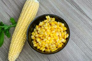Sweet corn in a bowl on wooden background photo