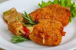 Fried cheese on the plate and wooden background photo