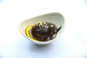 Profiterole in a bowl on white background photo