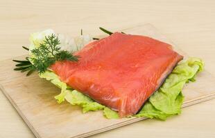 Salted salmon on wooden board and wooden background photo