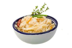 Fermented cabbage in a bowl on white background photo