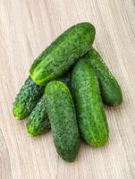 Cucumber on wooden background photo