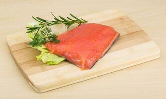 Salted salmon on wooden board and wooden background photo