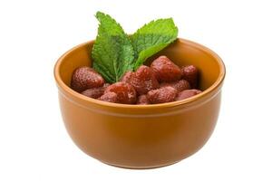 Marinated strawberry in a bowl on white background photo