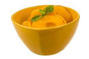 Marinated peaches in a bowl on white background photo