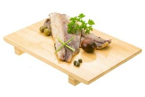 Herring on wooden board and white background photo