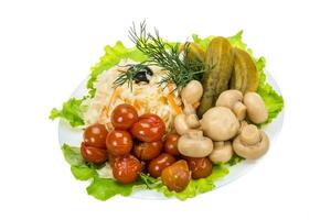 Marinated vegetables on the plate and white background photo