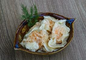 Shrimp wanton in a bowl on wooden background photo