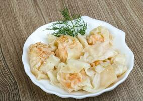 Shrimp wanton on the plate and wooden background photo