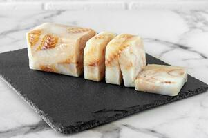 Frozen Fillet of Fish Pangasius on stone board ready for cooking. photo