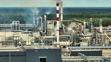 flight near pipes with white smoke of woodworking enterprise plant sawmill. Air pollution concept on industrial landscape video