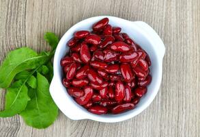 Kidney beans in a bowl on wooden background photo