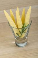 Baby corn in a bowl on wooden background photo