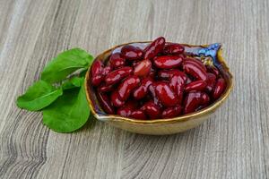 Kidney beans in a bowl on wooden background photo