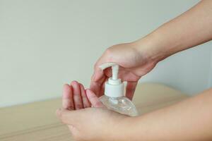 Woman using alcohol sanitizer gel rub for cleaning hand COVID-19 corona virus prevention concept photo