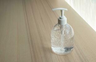 Alcohol sanitizer gel hand wash on wood table for covid-19 Coronavirus prevention concept photo