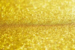 Abstract gold glitter sparkle with bokeh light background photo