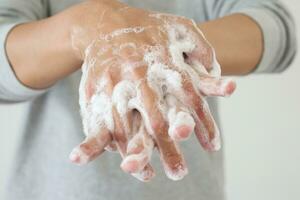 Man wash hands with soap for COVID-19 corona virus prevention concept photo