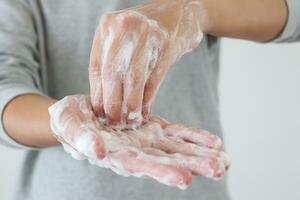 Man wash hands with soap for COVID-19 corona virus prevention concept photo