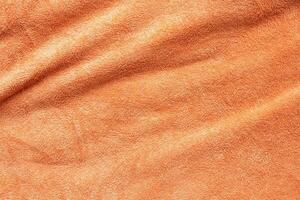 superficie de textura de tela de toalla naranja cerrar fondo foto