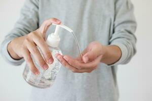 Man using alcohol sanitizer gel rub for cleaning hand COVID-19 corona virus prevention concept photo