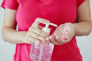 Woman using alcohol sanitizer gel rub for cleaning hand COVID-19 corona virus prevention concept photo