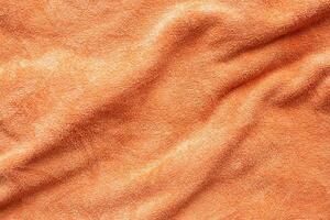 Orange towel fabric texture surface close up background photo