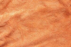 Orange towel fabric texture surface close up background photo